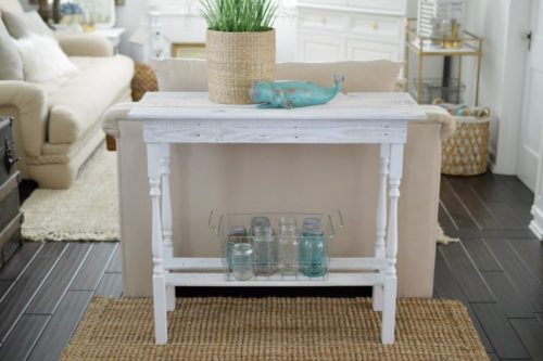 side table behind a couch that is whitewashed