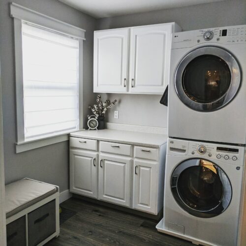 laundry room with repainted cabinets