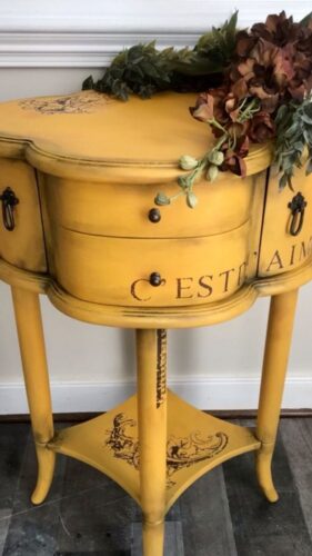 yellow side table with flowers on it