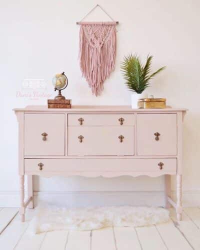 pale pink vanity with gold hardware in bedroom
