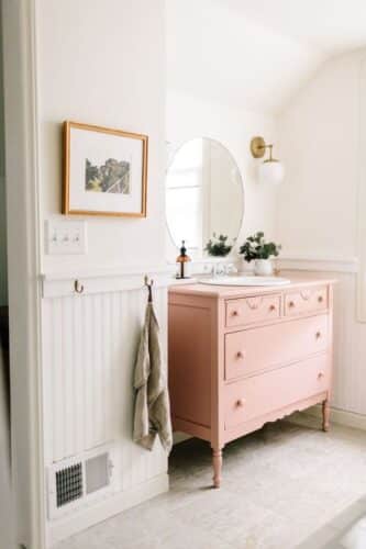 pale pink bathroom vanity next to white walls